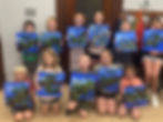 group of kids showing off their canvas painting during kids classes at the prairie arts center in north platte nebraska