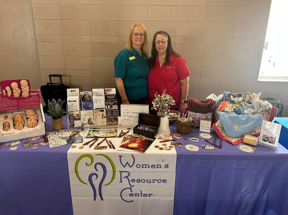 womens resource center booth with employees promoting services and mission