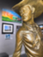 gold cowboy sculpture on display at the prairie arts center in north platte nebraska