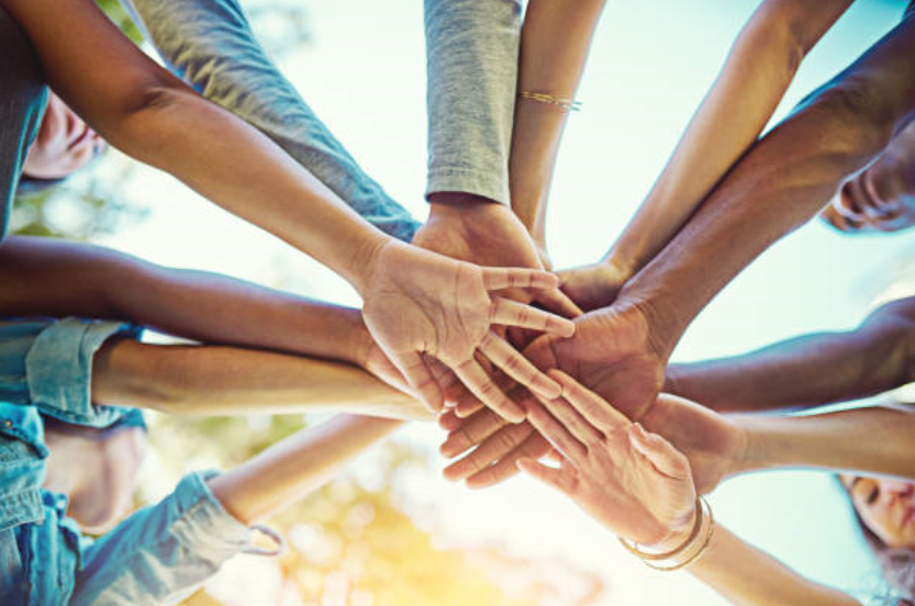 Team with Hands - About Us Page