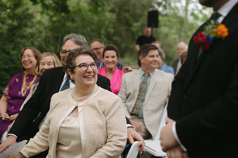 Mother of the groom watching ceremony during Houston Arboretum wedding