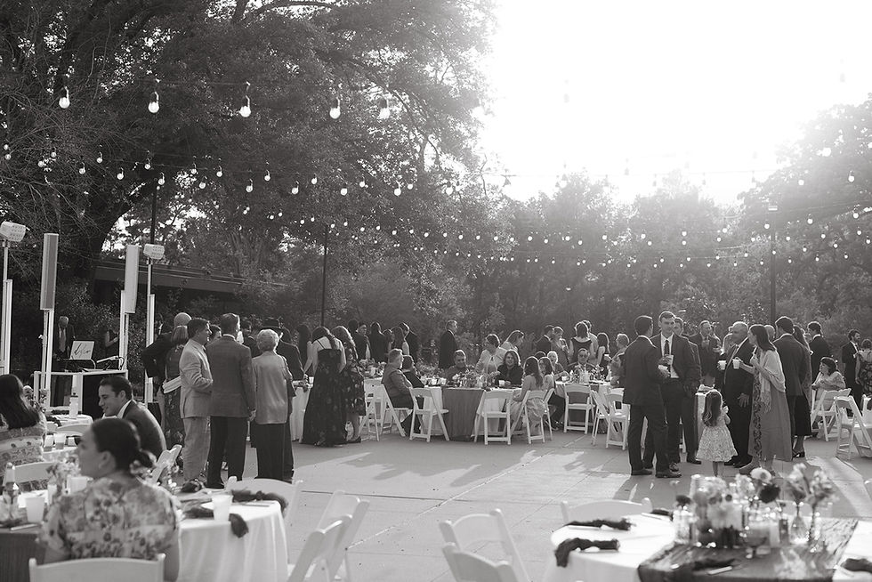 Guests mingling during outdoor cocktail hour at Houston Arboretum courtyard