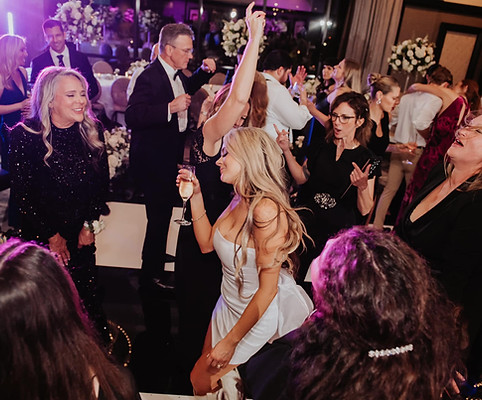 Bride dancing with wedding guests at The Post Oak hotel in Houston at a luxury wedding reception by D&Co Entertainment.