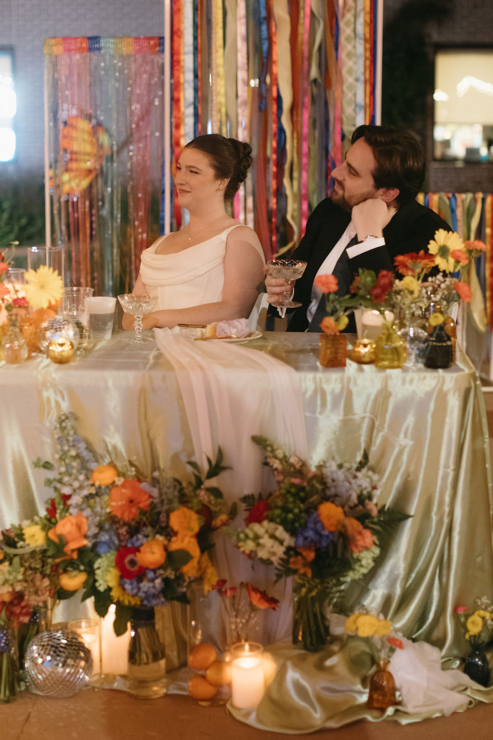 Bride and groom listening to wedding toasts during outdoor reception