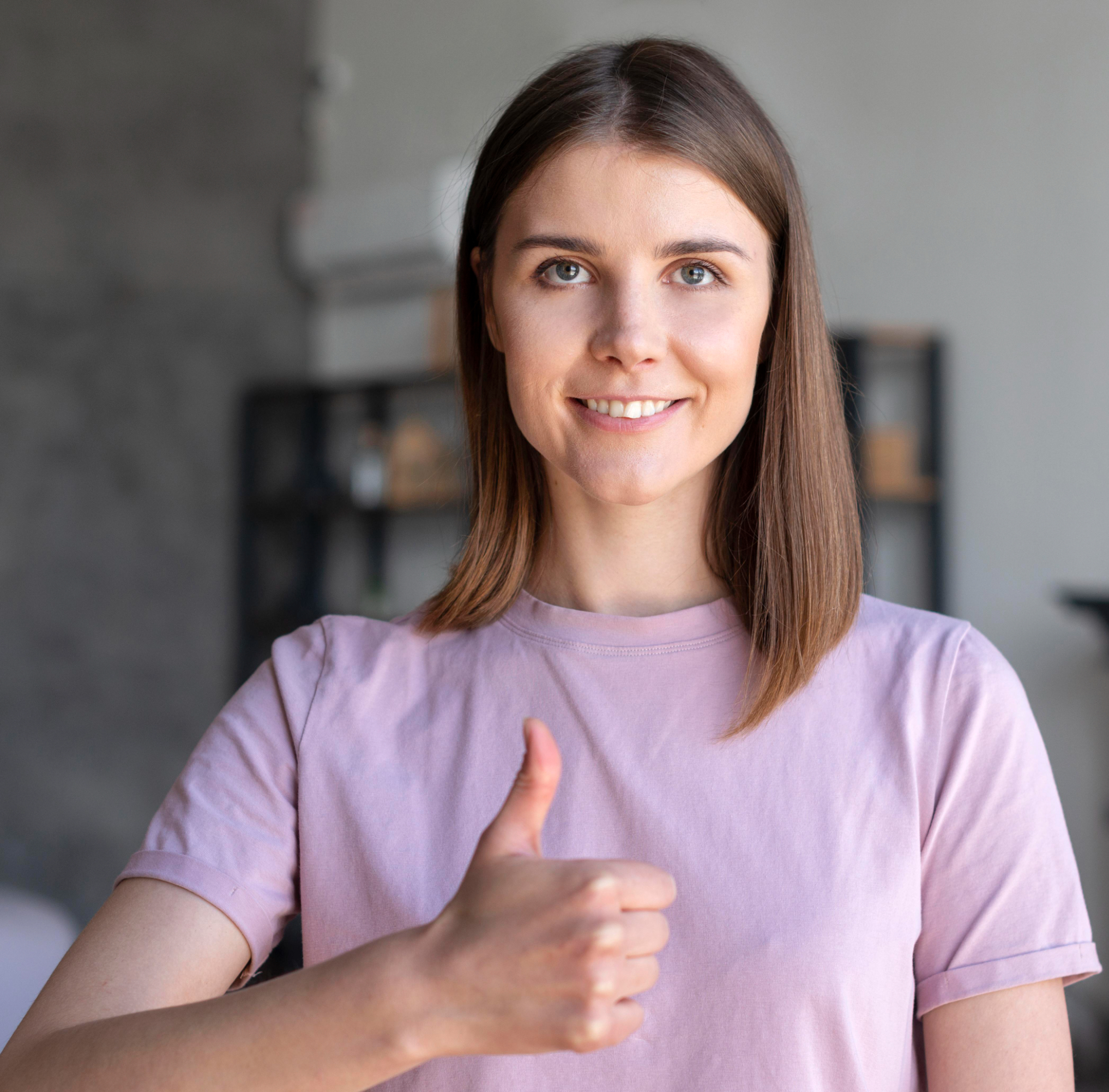 Smiling woman gives thumbs up