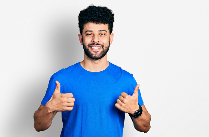 Smiling man giving thumbs up