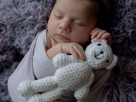 newborn baby sleeping with teddy
