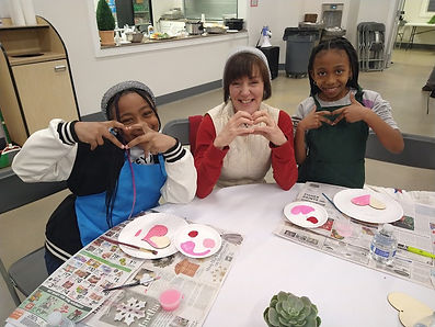 Mentor with students doing craft 
