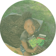 student holding seeds in garden
