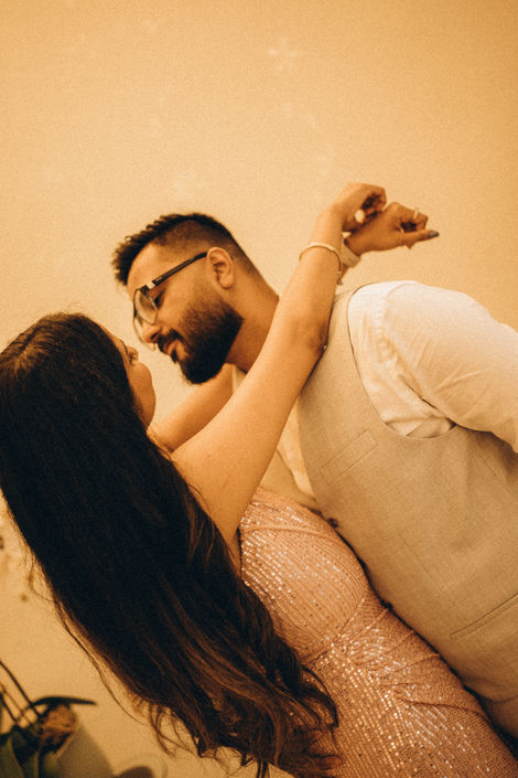 a man and woman are dancing together and the woman is wearing a pink dress