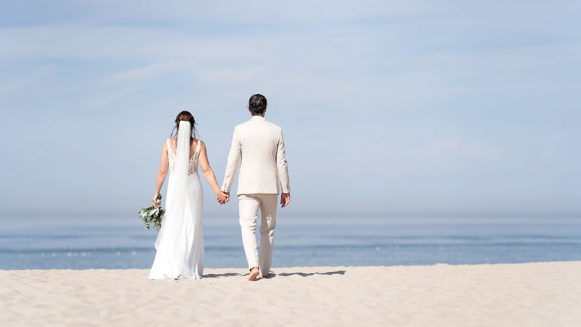 Wandeling van bruidspaar op strand van Scheveningen