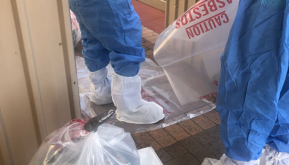 Asbestos removal safety setup with PPE, asbestos waste bags and controlled entry area in Western Sydney