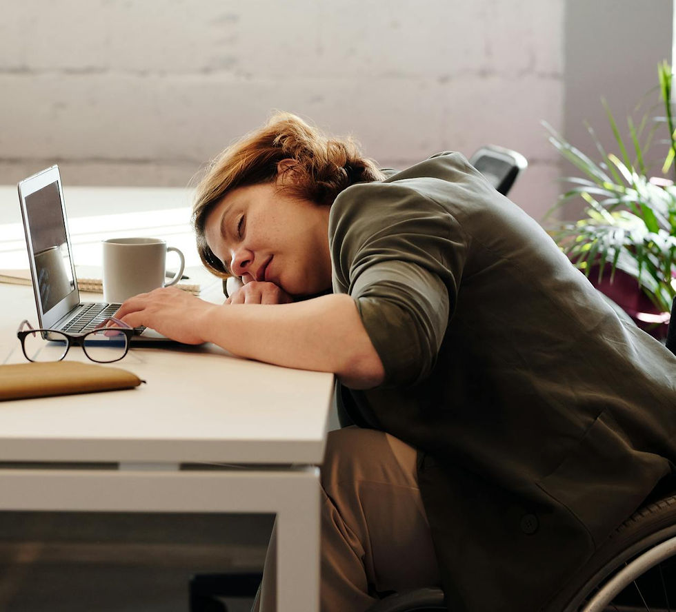 woman fatigued at her desk.