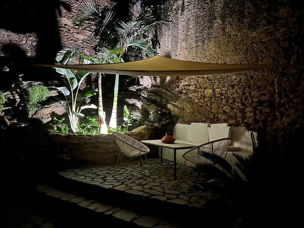 Illuminated outdoor seating area of a boutique apartment.