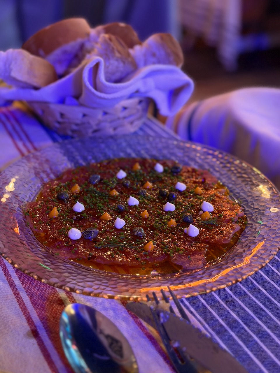 Bright red tuna carpaccio with Japanese mayonnaise, citrus zest, chili oil, and capers at Cantina Villa Picante.