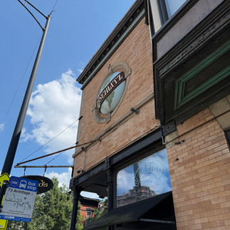 Restored Schlitz tied-house in Wicker Park Chicago with colorful belted globe emblem, built in 1898 as a brewery-owned tavern.