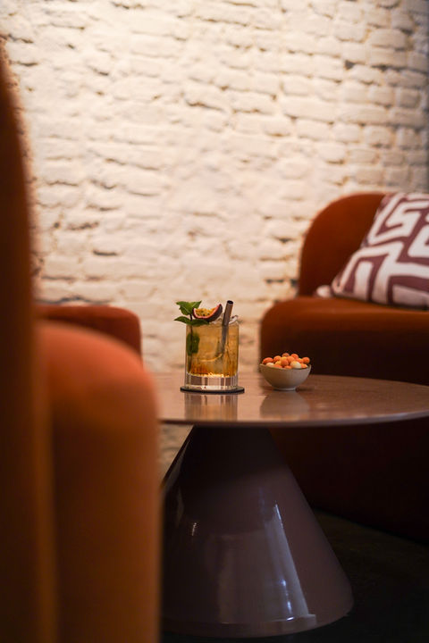 Cocktail on a table in a lounge with brick walls
