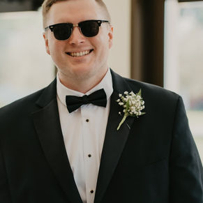 groom in sunglasses kissing