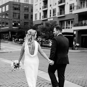 bride and groom holding hands walking on street