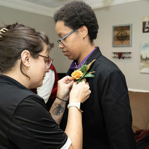 woman pinning on boutonniere