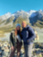 Adventurous hiking couple in front of snowcapped mountain Mt. Cook in New Zealand