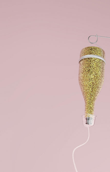 Bottle of champagne in shiny sparkling w