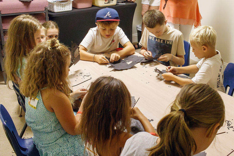 Children craft together at a table, Grace Kids, creating paper crafts, learning activities.