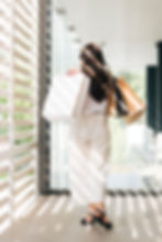 back-view-trendy-woman-holding-shopping-bags.jpg