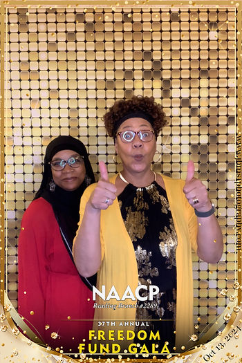 Posing at the photo booth giving 2 thumbs up