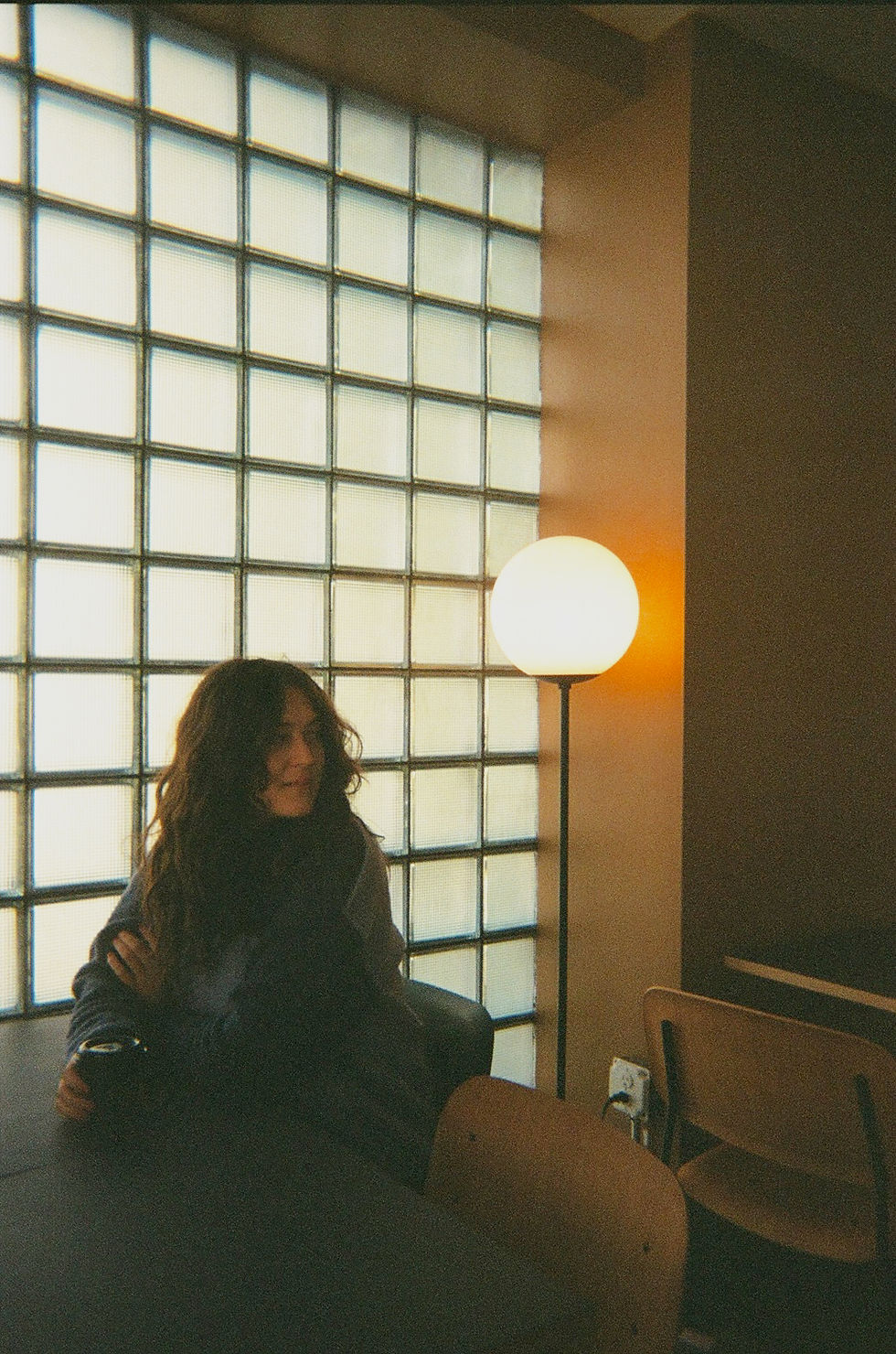 Woman sitting in a midcentury coffee shop