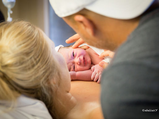 mom and dad looking at their newborn baby