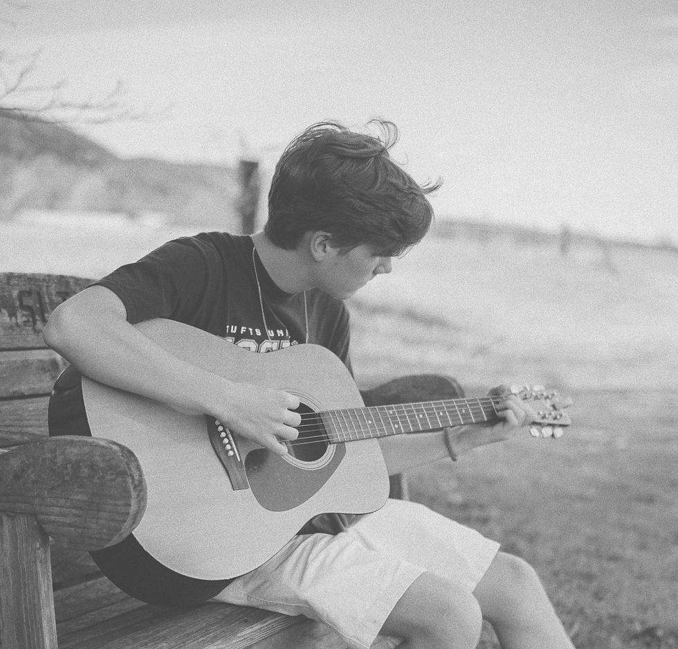 man playing brown acoustic guitar_edited_edited.jpg
