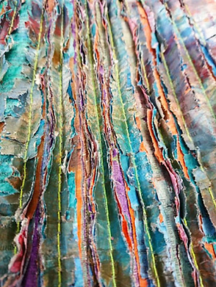 Recyled papers layered and machine stitched and then cut.