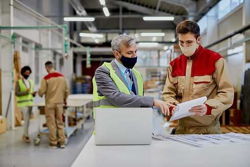 mid-adult-engineer-male-worker-wearing-face-masks-while-examining-paperwork-woodworking-fa