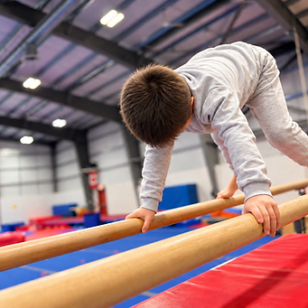 Young Gymnast Balancing on Parallel Bars.png