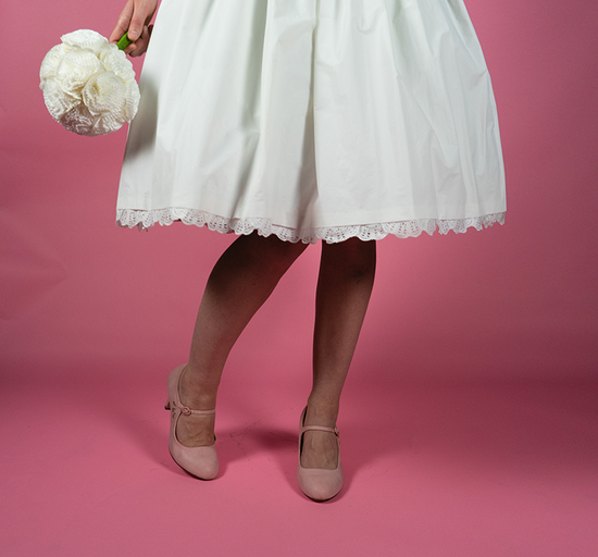 Wedding dress made of cupcake liners, paper doilies, pipecleaners, a plastic tablecloth, and plastic mesh. All held together with hot glue, scotch tape, glue stick, and 3M Command Strips.
Photo credit: Autumn Bennett.