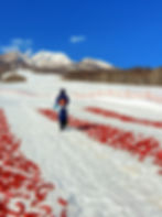 Spreading out the chilis on the snow, in front of Mount Myoko