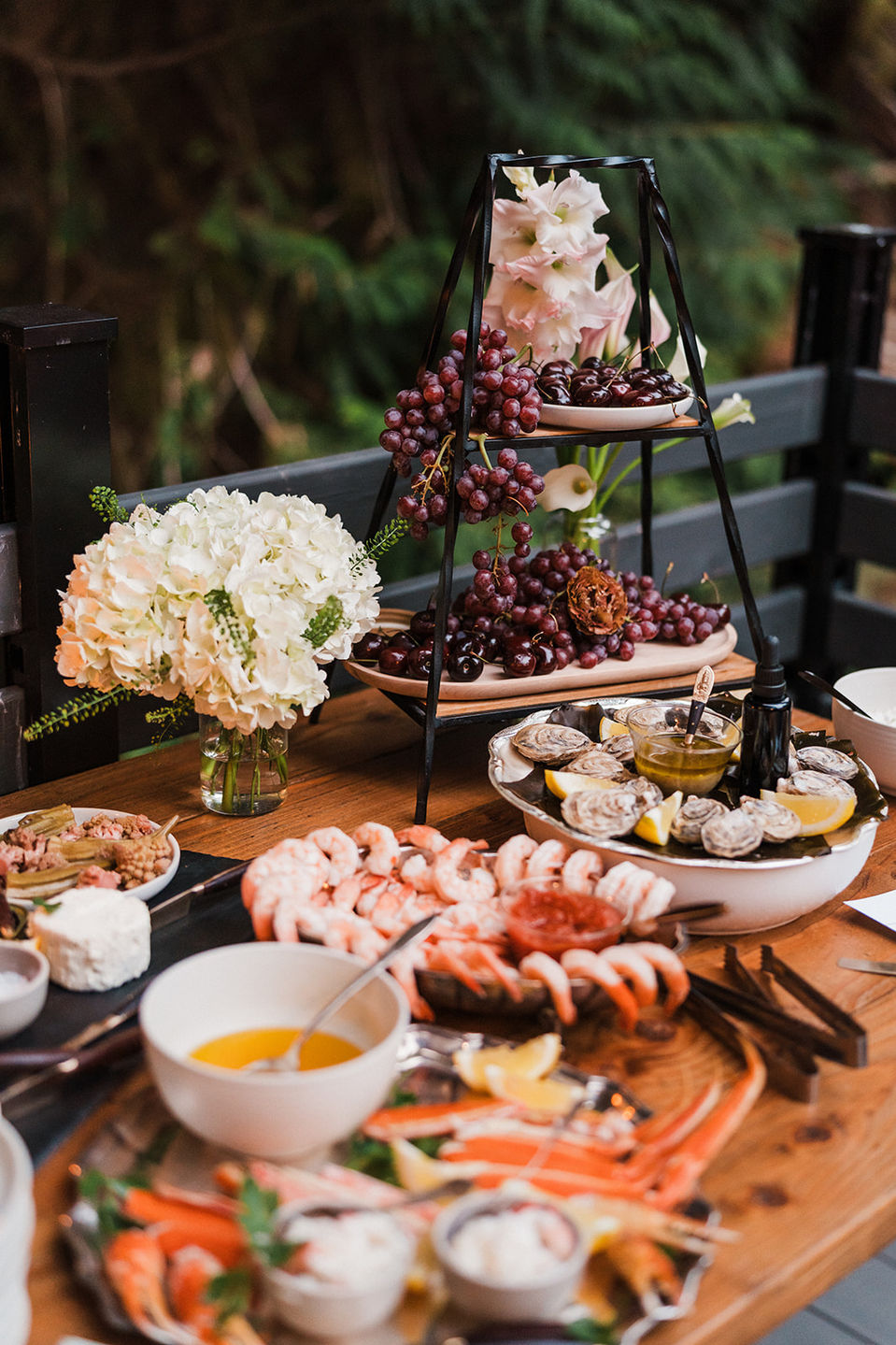Seafood Grazing Tower, Shrimp Cocktail, Crab Legs with Butter, Fresh Oysters with Spruce Tip Mignonette, Fruit and more.