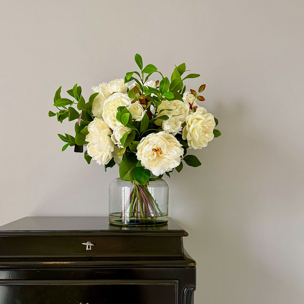 luxury, lifelike white flowers set in faux water in a clear vase