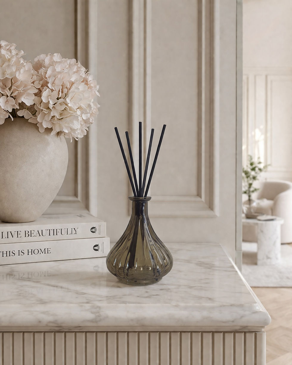 Luxury ribbed glass reed diffuser with black reeds on marble kitchen island by Whispering Lily