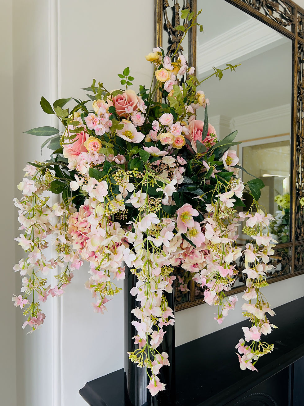 faux pink flowers in a tall vase