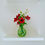 Thumbnail: artificial poppy set in resin water in a green bud vase