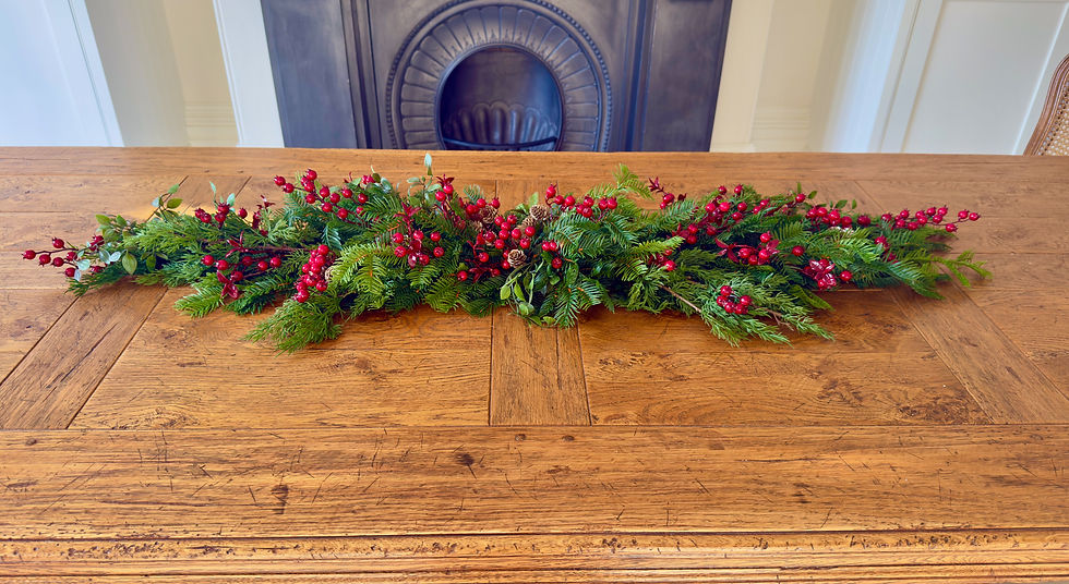 Thumbnail: Long, low Scarlett Winterberry Christmas table centrepiece with realistic evergreen foliage, glossy red berries and pine cone