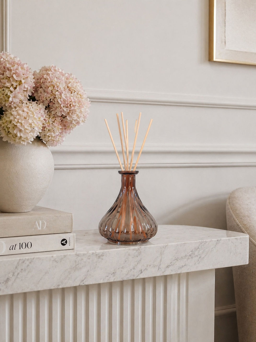 Luxury ribbed glass reed diffuser with natural reeds on marble kitchen island by Whispering Lily
