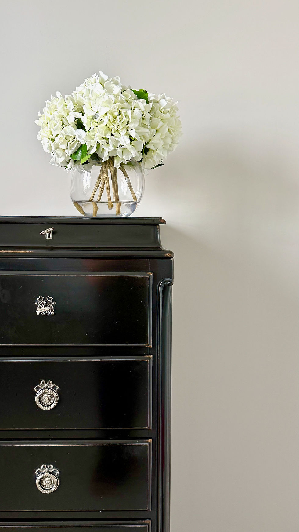 Thumbnail: white real touch hydrangeas set in faux water in a gold fish vase in stylish setting