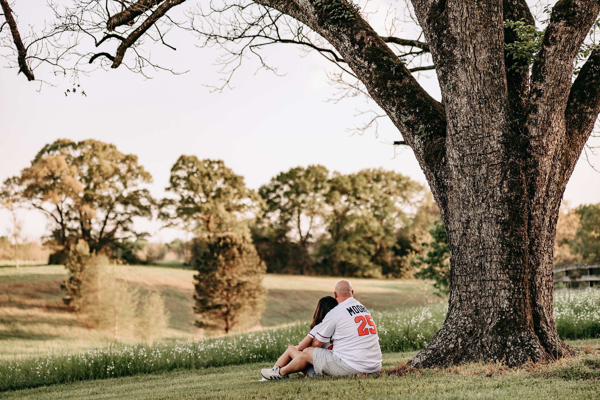 Morgan and Andy smiling at each other during their engagement session at The Wedding Barn at L'Horne