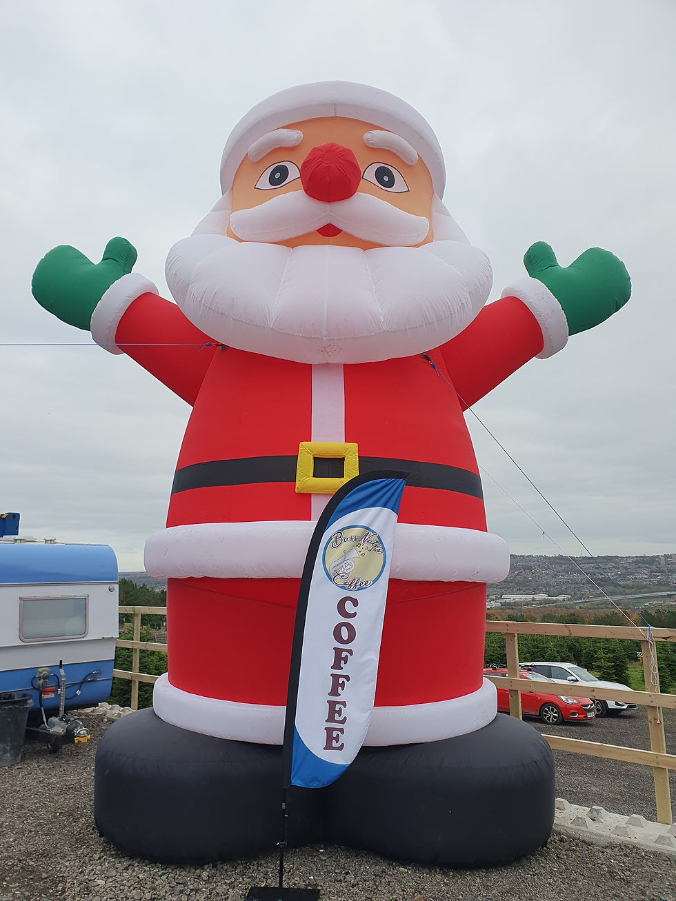 A huge inflatable Santa dwarfing the Bass Notes Coffee flag at Lamesley Christmas Tree Farm