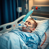 patient in bed with ventilator.jpg