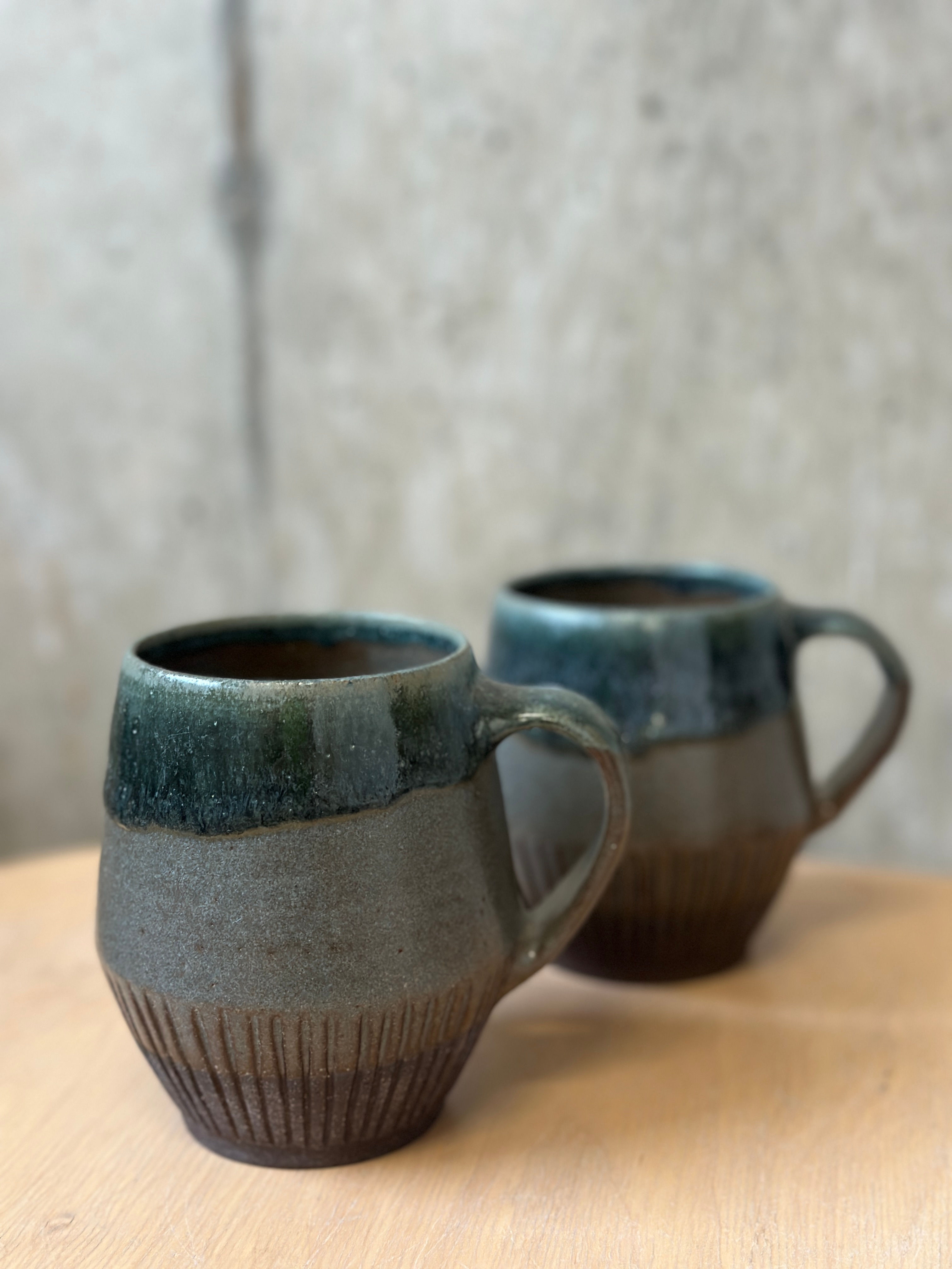 Retro mugs on dark chocolate clay.
