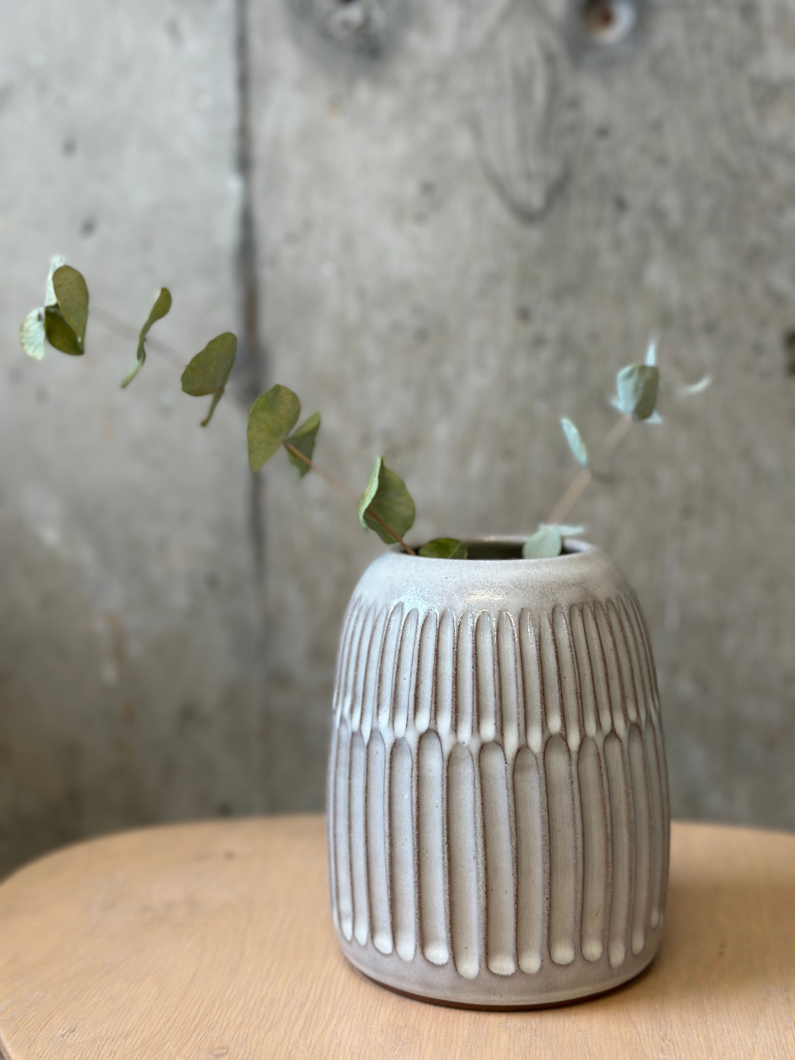 Hand-fluted vase in an oat milk glaze.